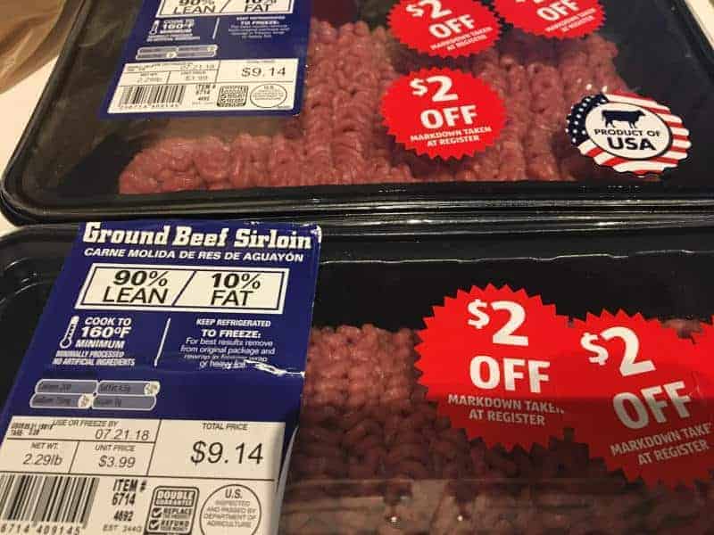 Packages of Aldi stores fresh ground sirloin with two $2 off stickers for nearing sell-by date