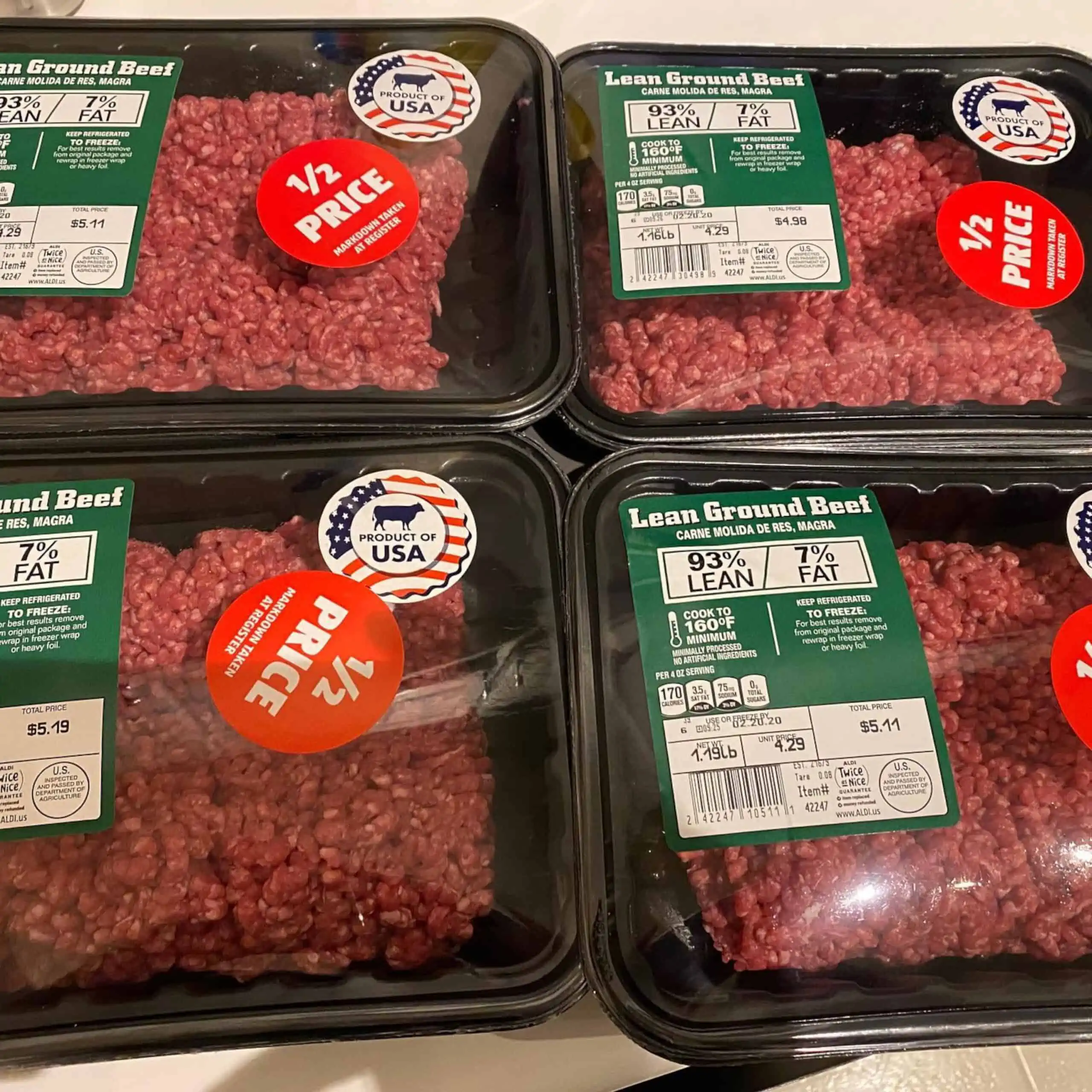 Packages of Aldi stores fresh ground beef with 1/2 prices stickers for nearing sell-by date