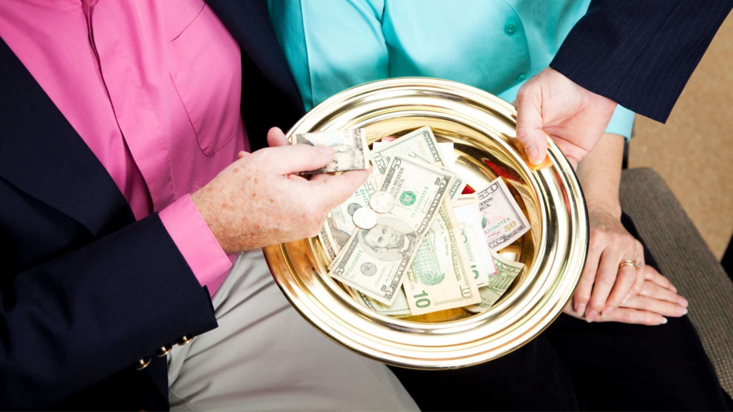 Couple at church giving charitable contributions in the collection plate