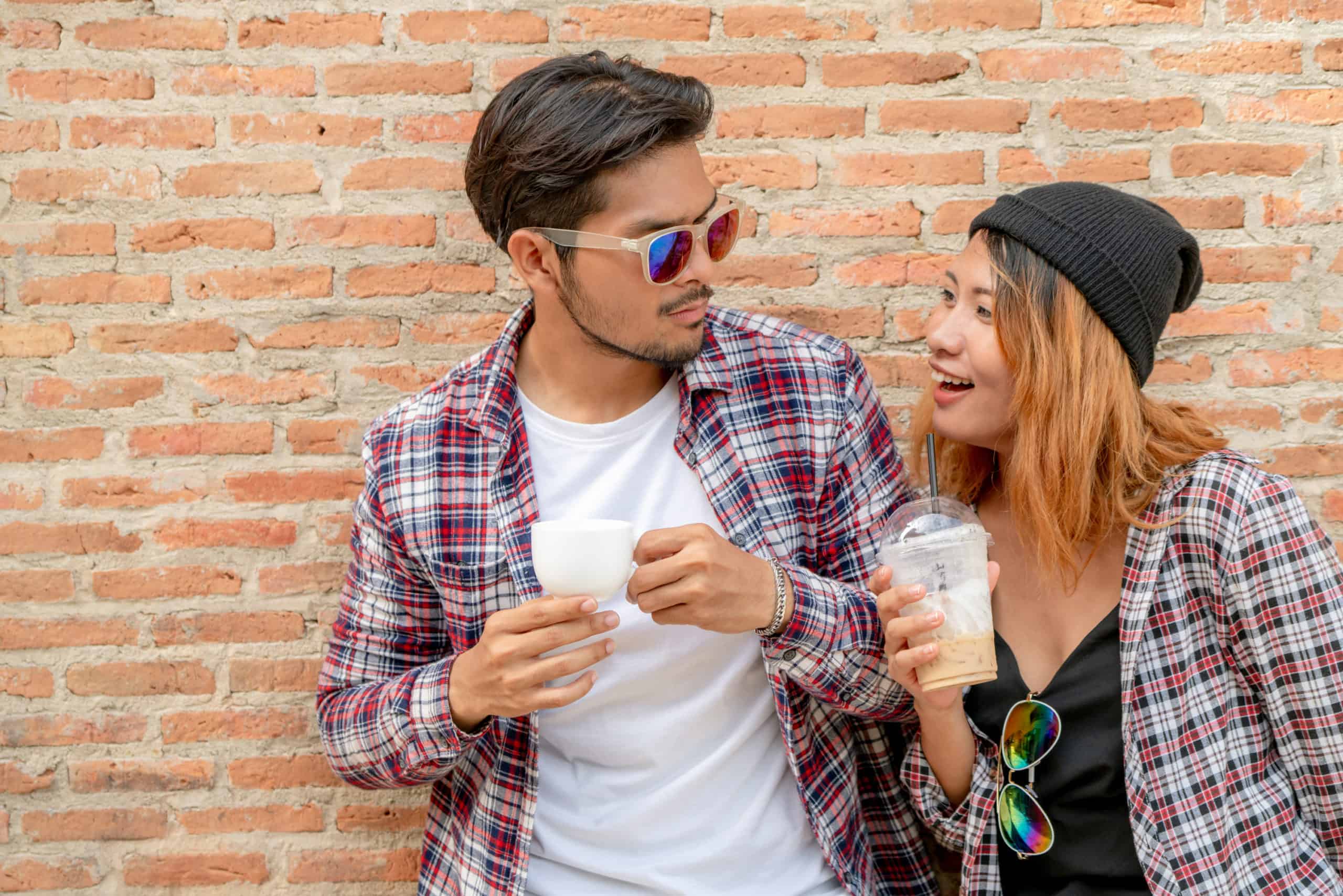 Happy young man and woman drink coffee on a first date
