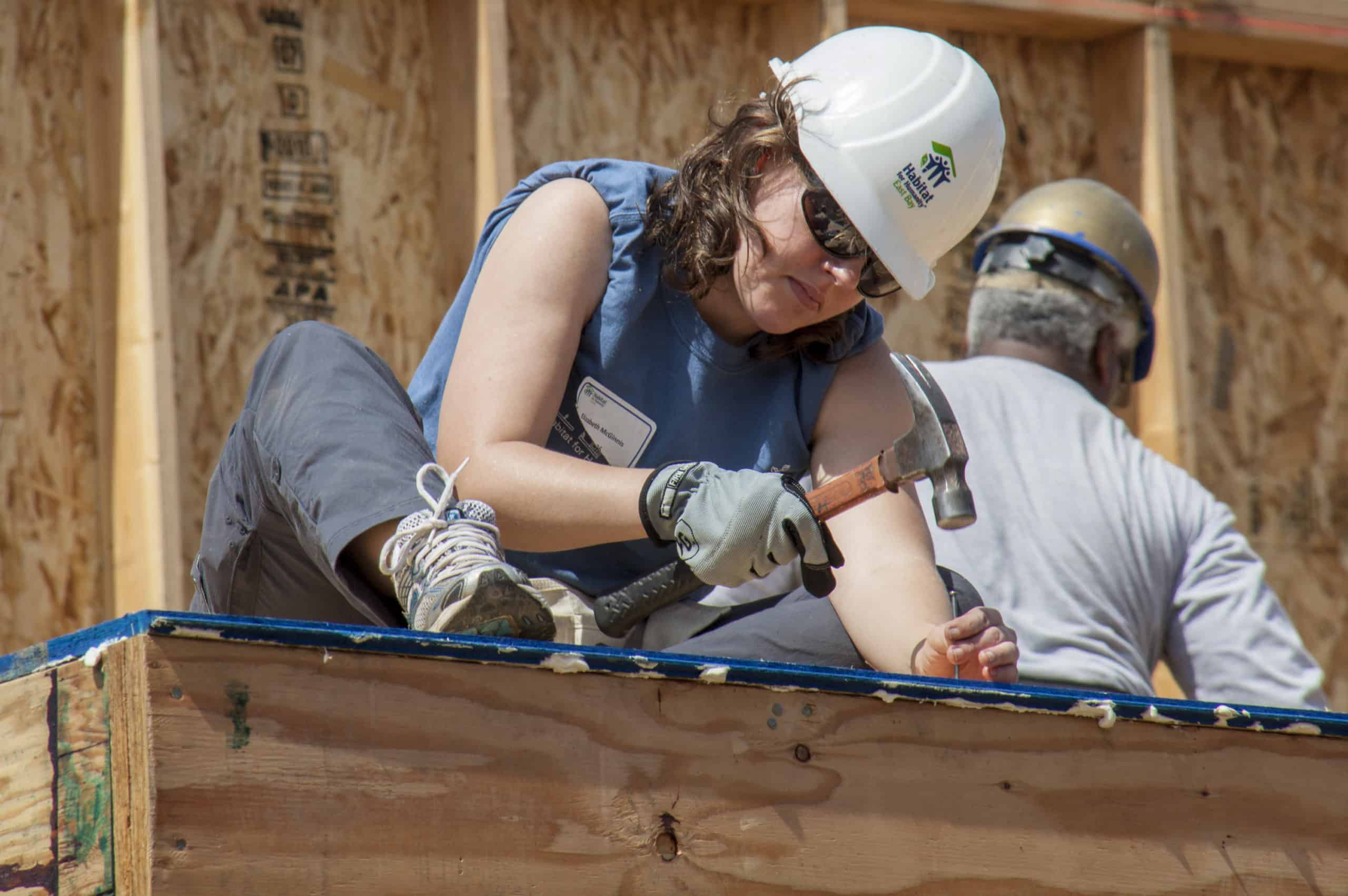 How To Donate To Charity When You Don't Have The Cash 3 Woman deciding to donate to charity by joining Habitat For Humanity to build a home