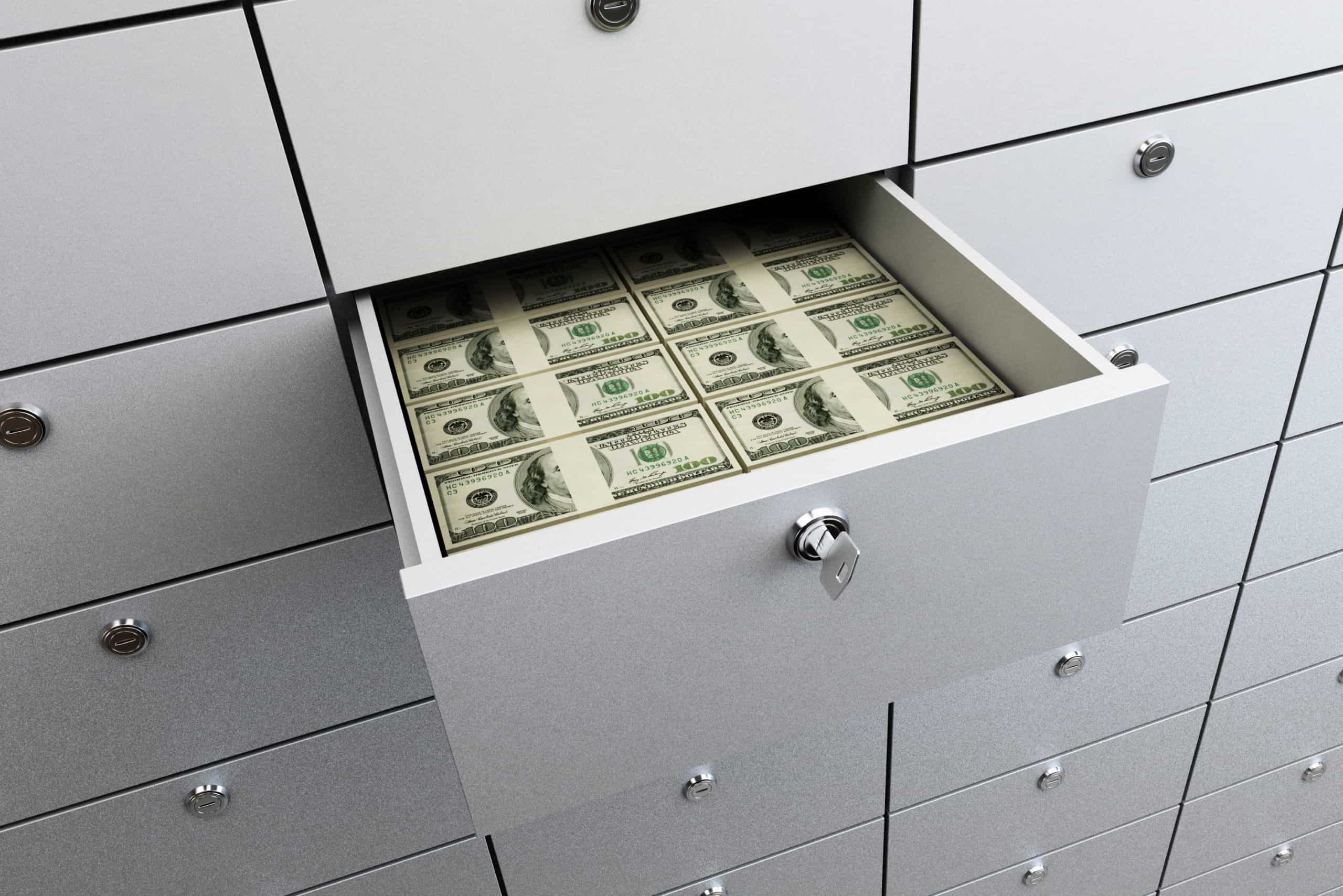 Brand new hundred dollar bills strapped and stored in a bank vault safe deposit box for an emergency fund
