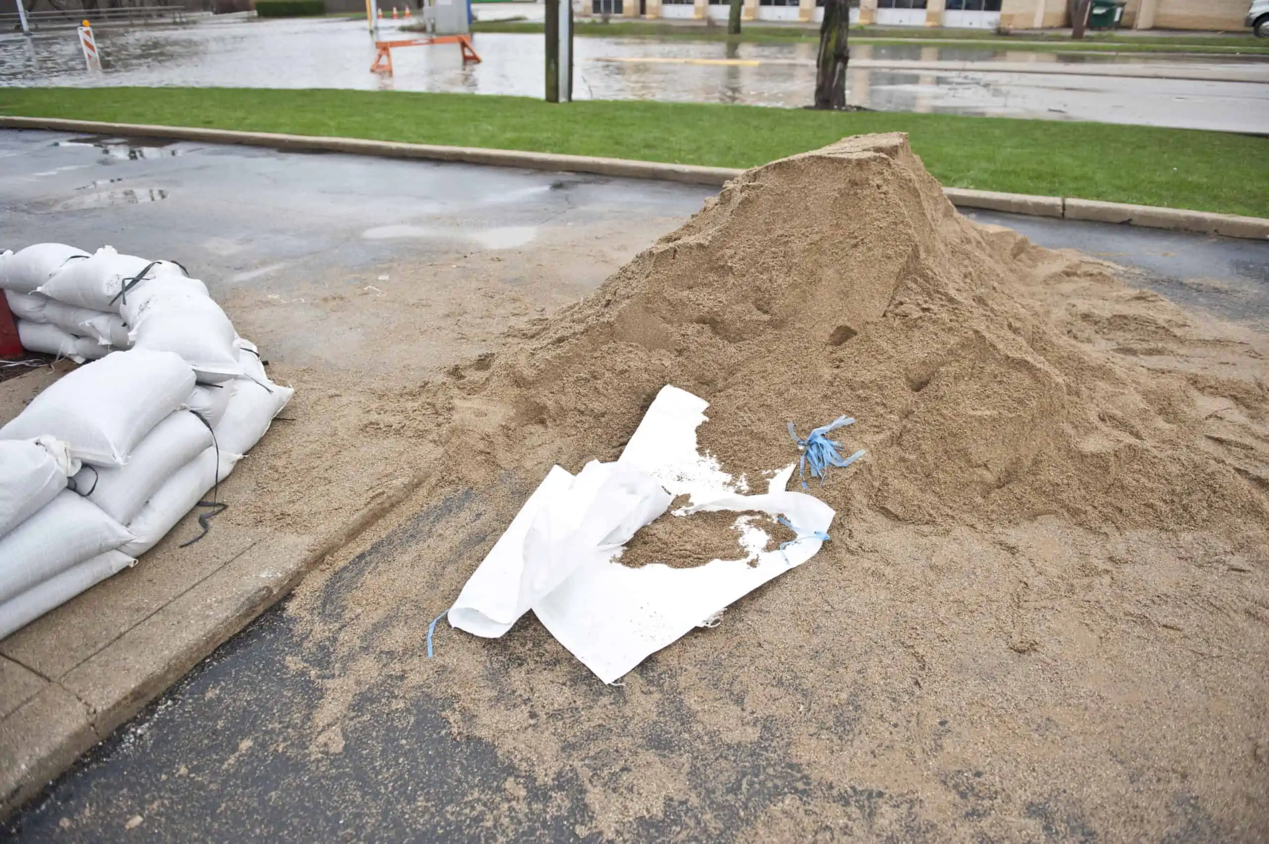 Pile of sand and empty sacks to make sandbags for your emergency preparedness supply kit