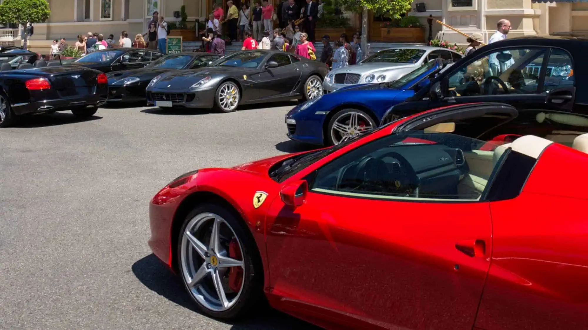Expensive cars including Ferrari, Rolls Royce, and Bentley on display to the public