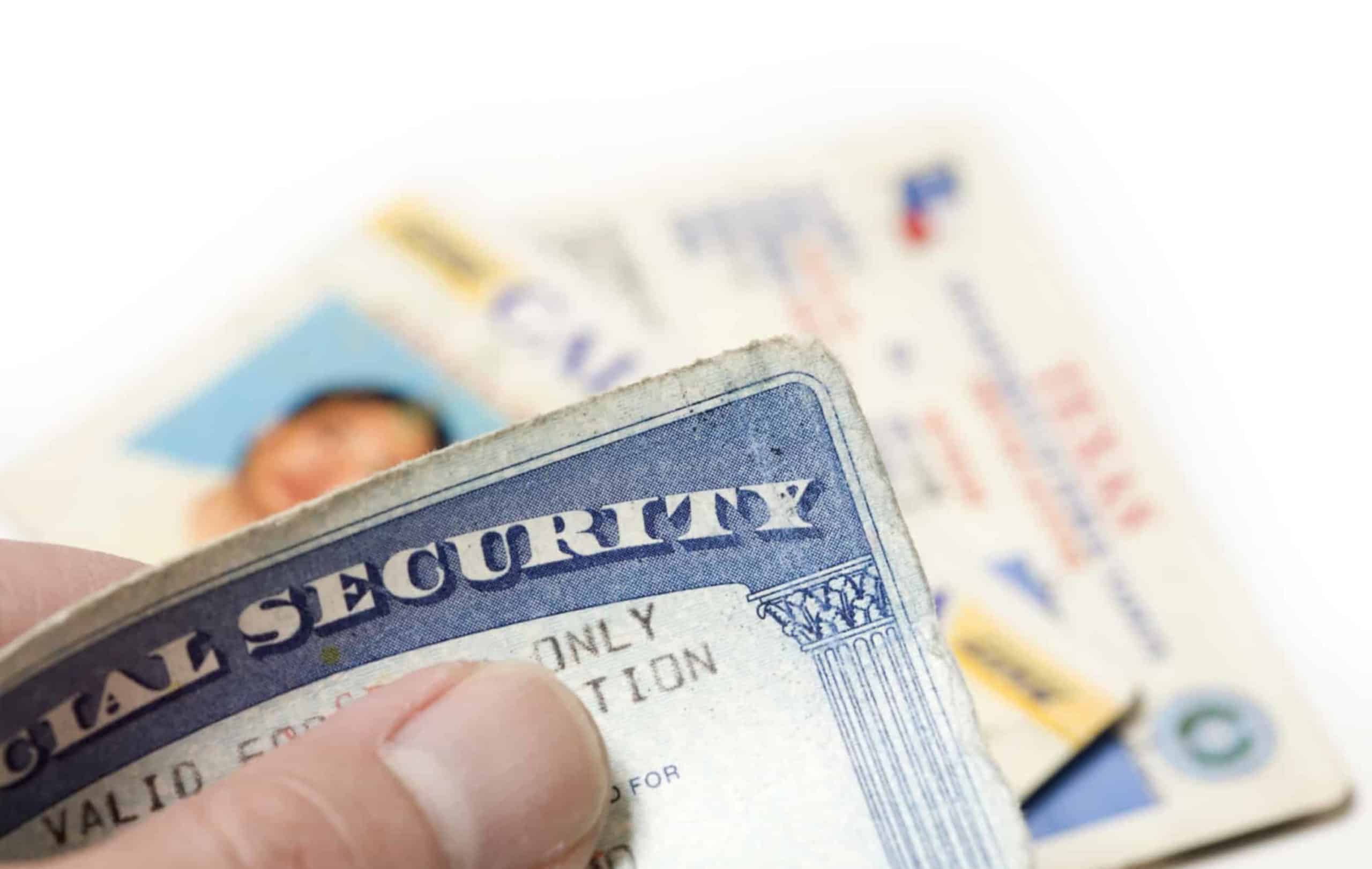 Man holding Identity theft documents-social security card, drivers license, voter registration card.