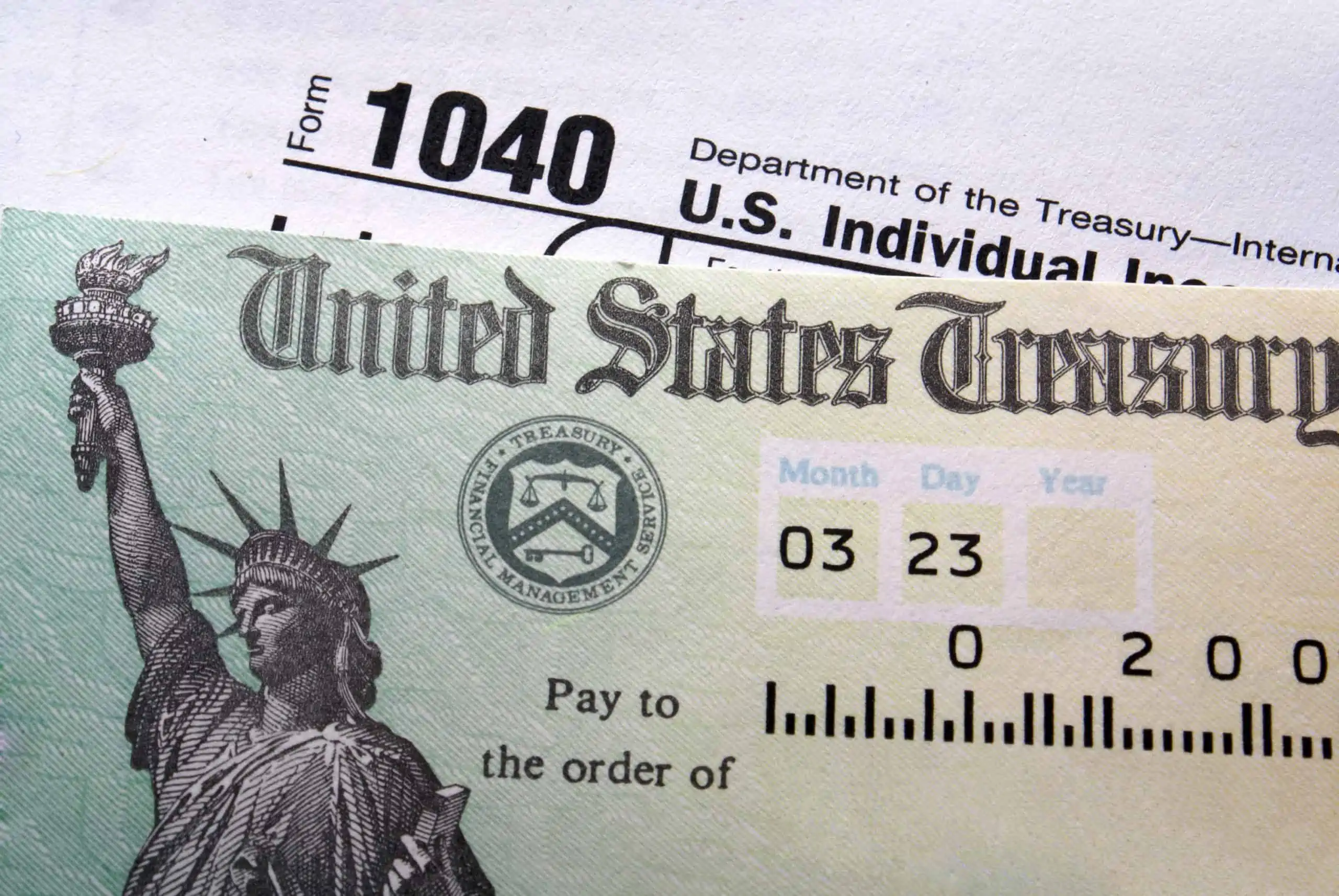 Tax refund check with income tax return form 1040