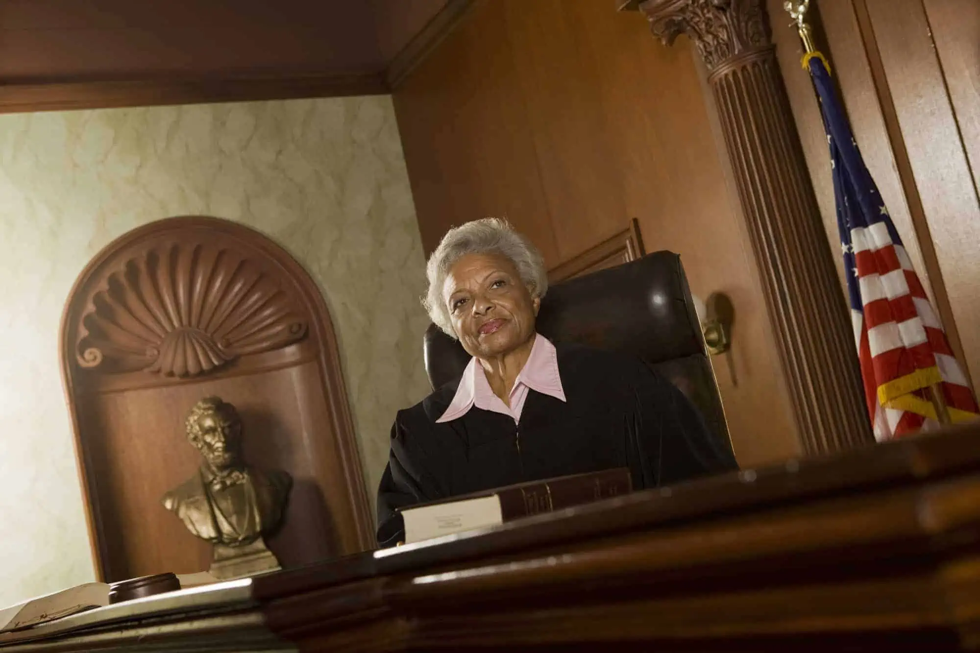 Black female judge presiding over a civil case due to bad do-it-yourself legal contracts.