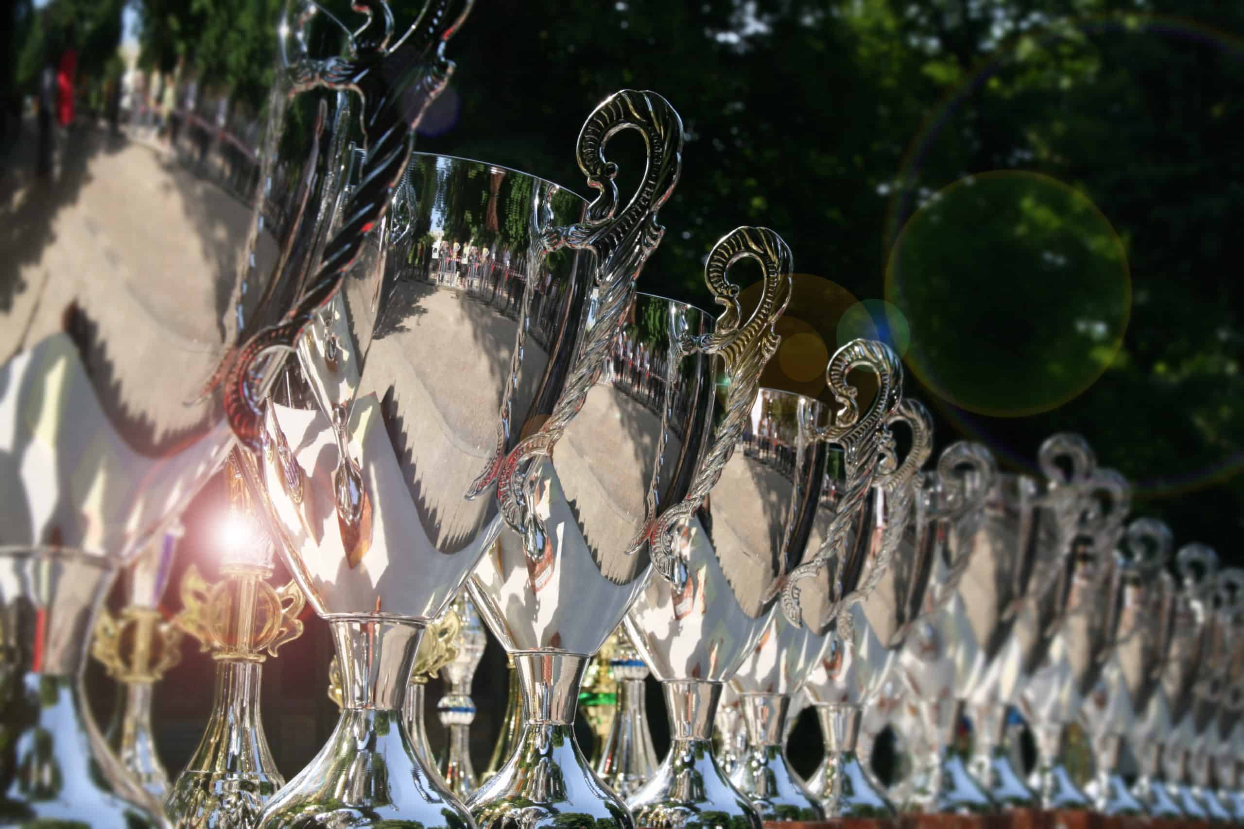 Table full of polished silver trophies used as a marketing trick to show how many awards were won