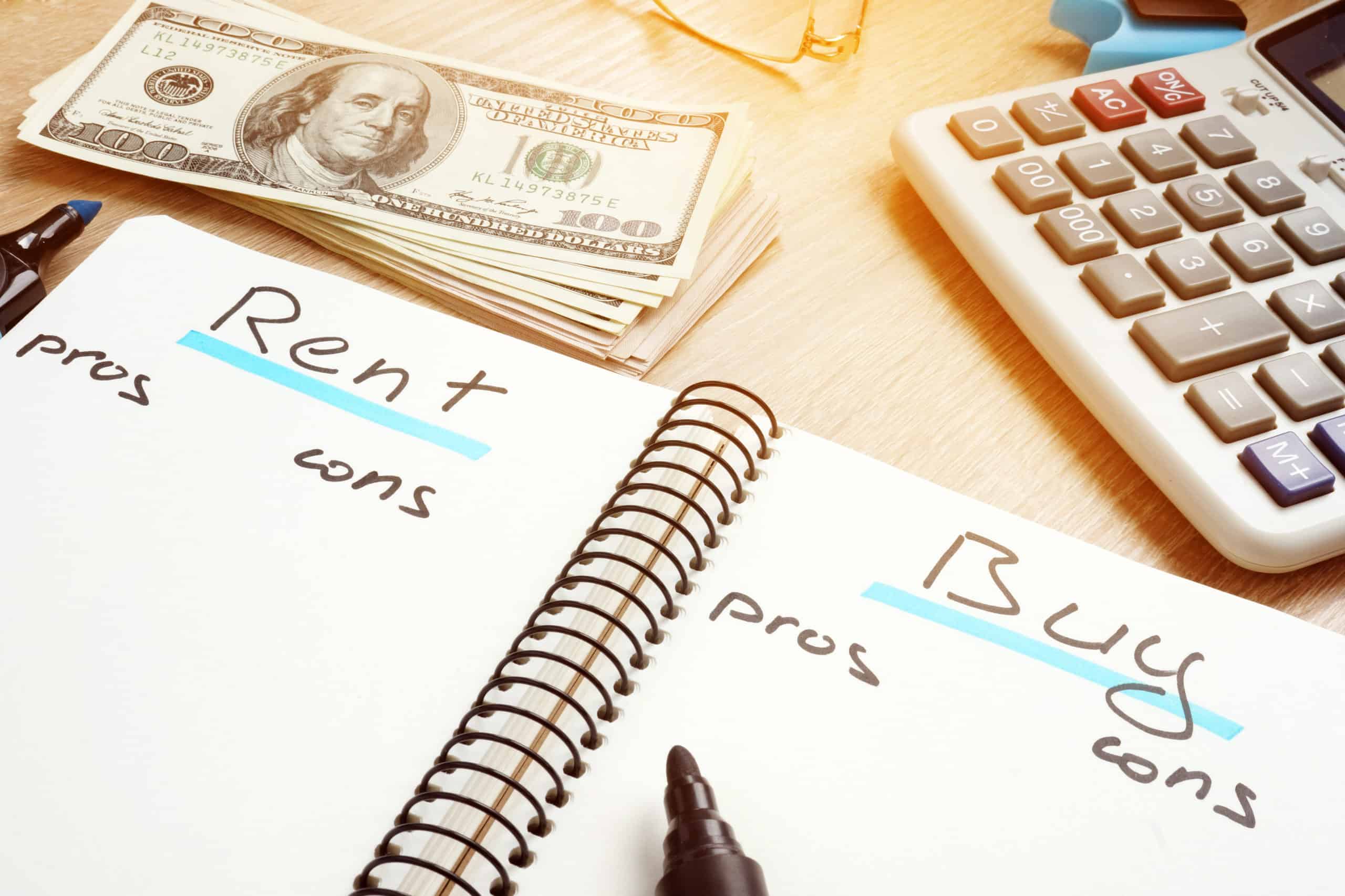 Notebook comparing the pros and cons of rent vs buy decision.