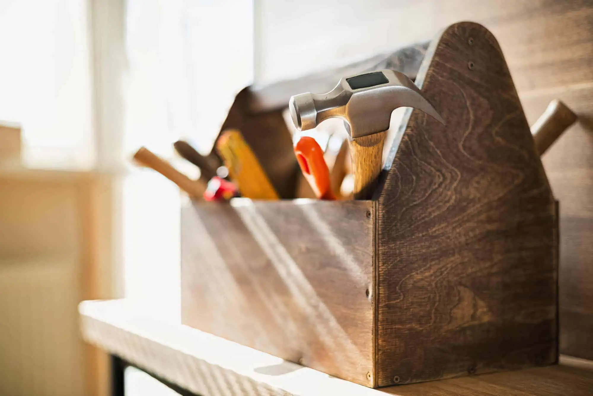 Wooden toolbox on a landlord's shelf for repairing a rental home.